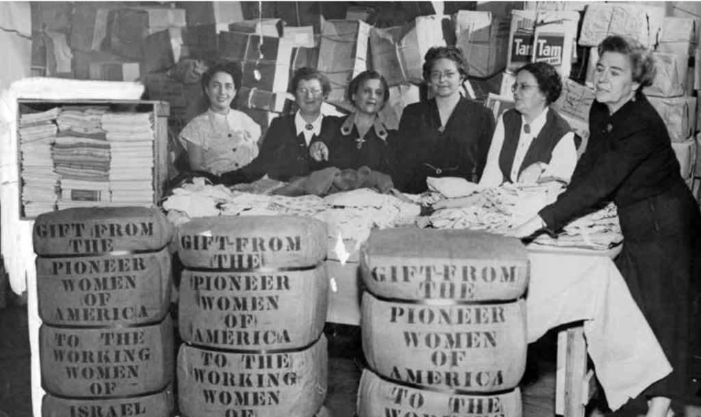 Moetzet Hapoalot representatives sort through gifts donated by Pioneer Women in 1950.